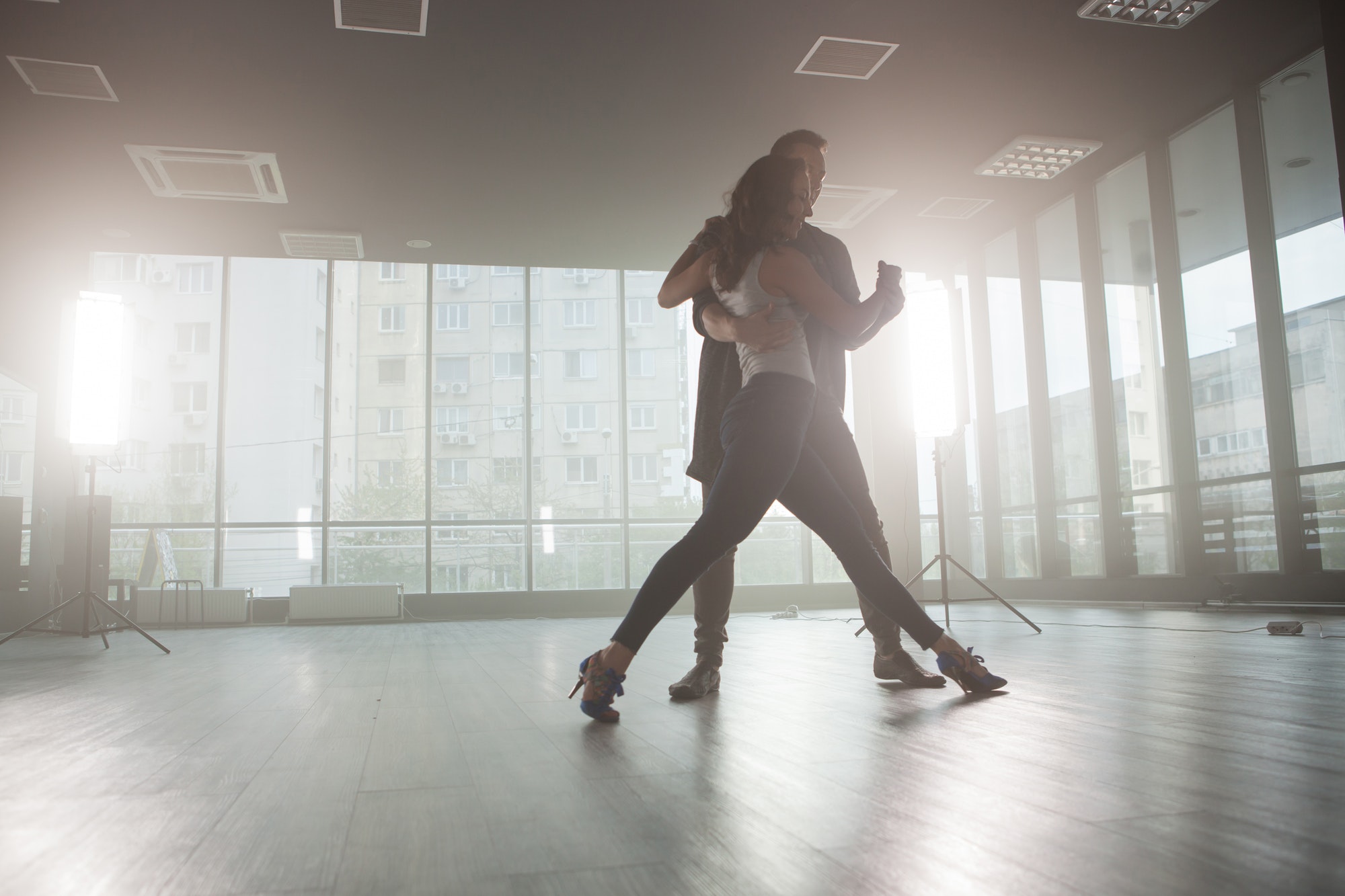 Kizomba dancers showing their passion for dancing kizomba in front a dancing room with big windows